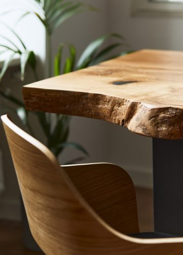 Stylish and cozy compositon of craft oak wooden table with chairs, plant and modern floor in beautiful interior of design home. Template.